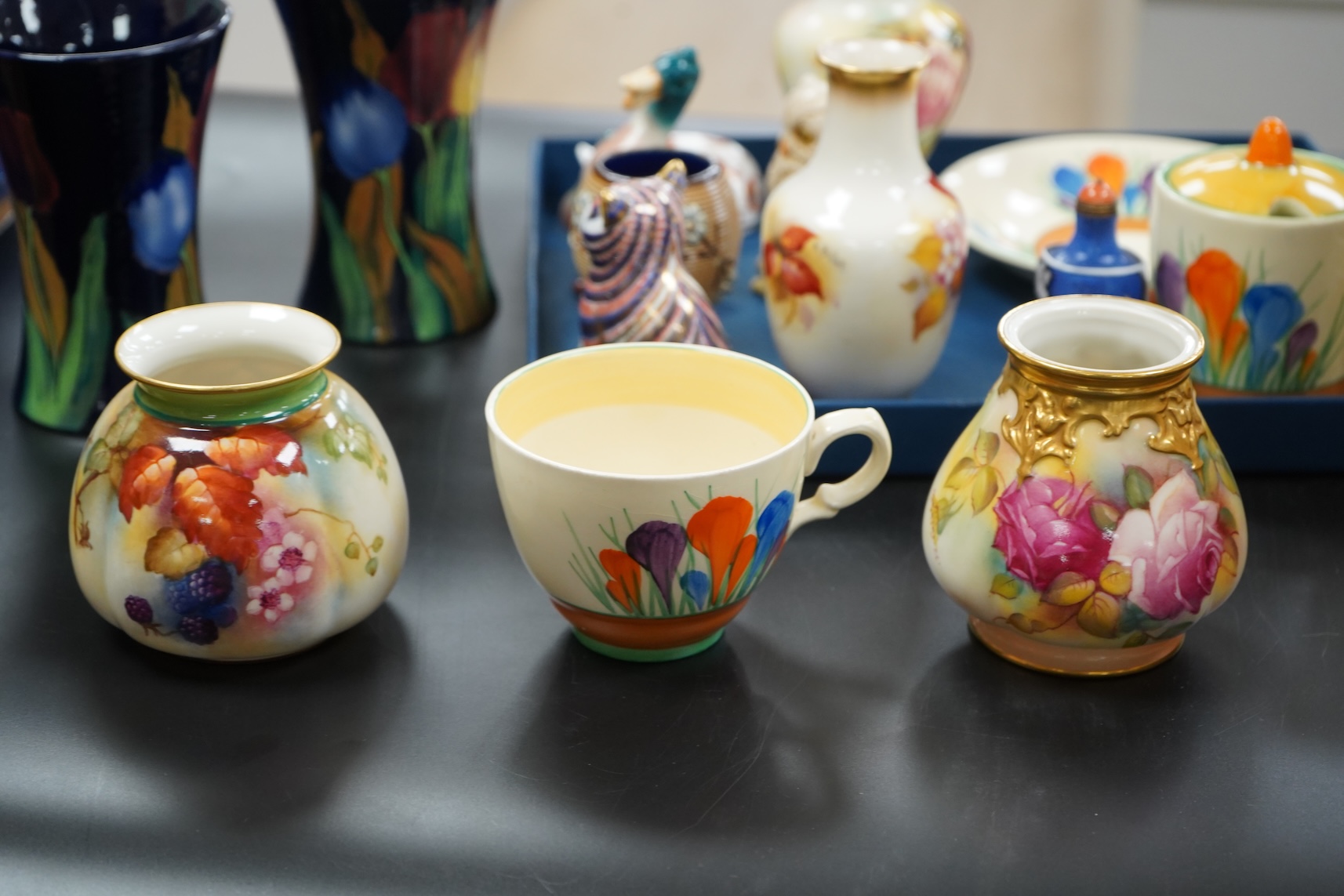 A collection of mixed porcelain and pottery to include four Worcester vases, one signed H. Blake, Clarice Cliff crocus pattern cup, saucer and sugar bowl and two Doulton Imari paperweights, largest 13cm high